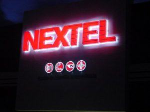 A neon sign that reads " nextel ".