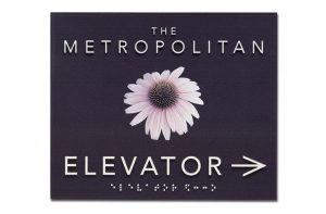 The metropolitan elevator sign with a safety icon.