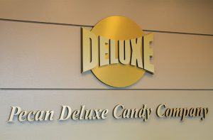 Pecan deluxe candy company lobby logo.