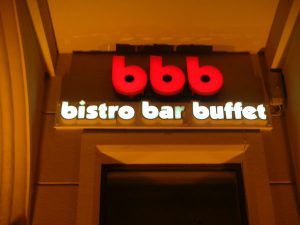 A sign for the bistro bar buffet in front of a building.