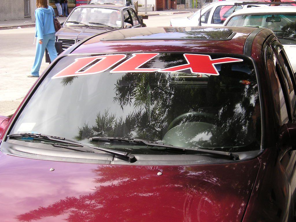 A red car with the number 1 0 7 on it's windshield.