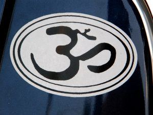 A sticker of an om symbol on the side of a boat.