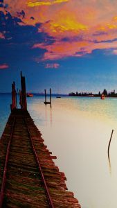 A stunning sunset over a dock, perfect for wall graphics.