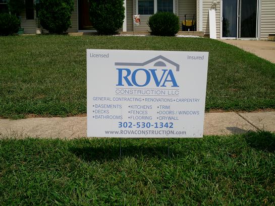 A sign in front of a house that says rova construction.