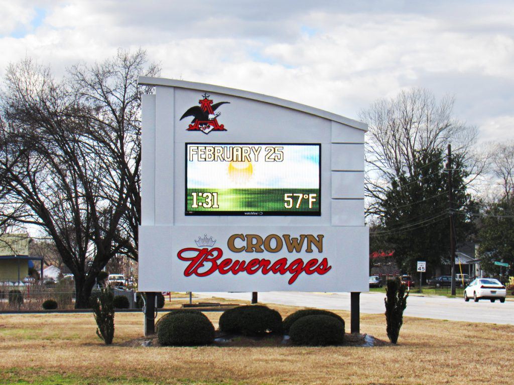 A large screen television set sitting in the middle of a field.