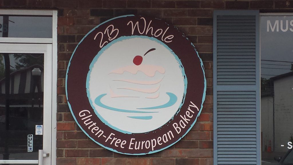 A sign for 2 b whole gluten free bakery