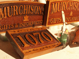 A wooden sign with numbers and the date of murchison 's.