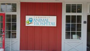A sign on the side of a building that says " tamekly animal hospital ".