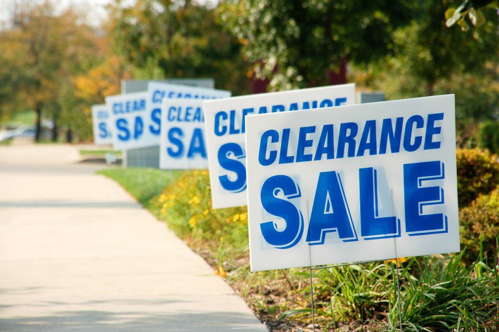 A row of sale signs on the side walk.