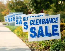 A row of sale signs on the side walk.