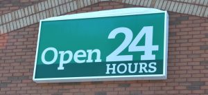 A sign that says open 2 4 hours.