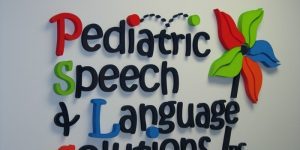 A sign that says pediatric speech language solutions