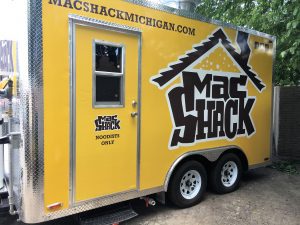 A yellow trailer with the words mac shack michigan on it.