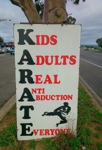 A sign on the side of the road that says karate.