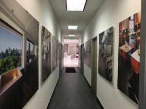 A hallway with many pictures on the wall